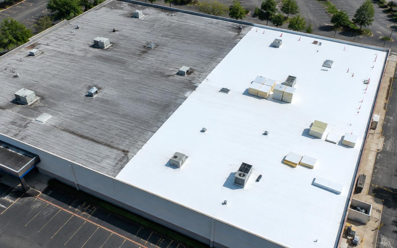 AI illustration: aerial view of a large store roof, half old gray sheet and half new white sheet, with foam boards stacked